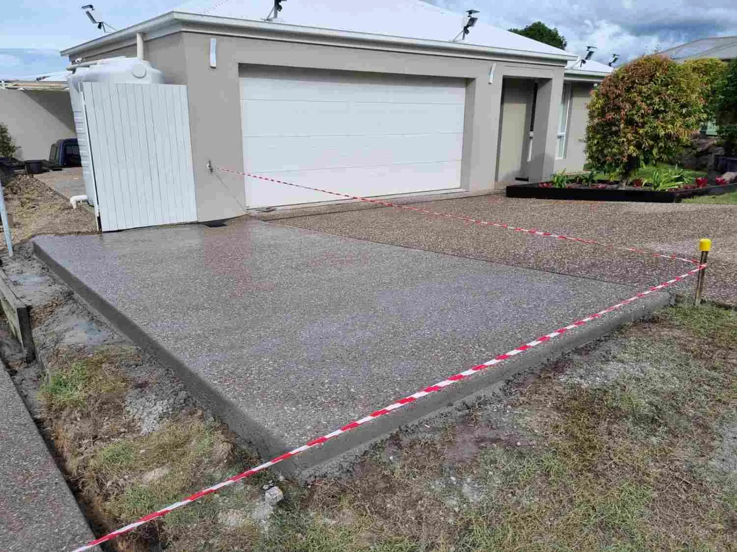 Exposed aggregate concrete driveway completed by Riverstone Concrete